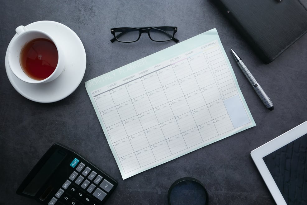 Calendar Planner, Tablet, Coffee, and Office Supplies on Table