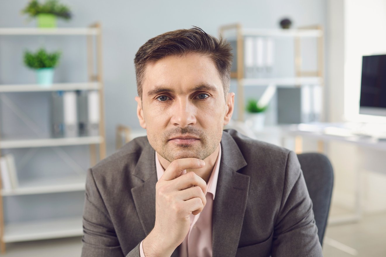 Business Man Looking at Camera during Videocall in Office